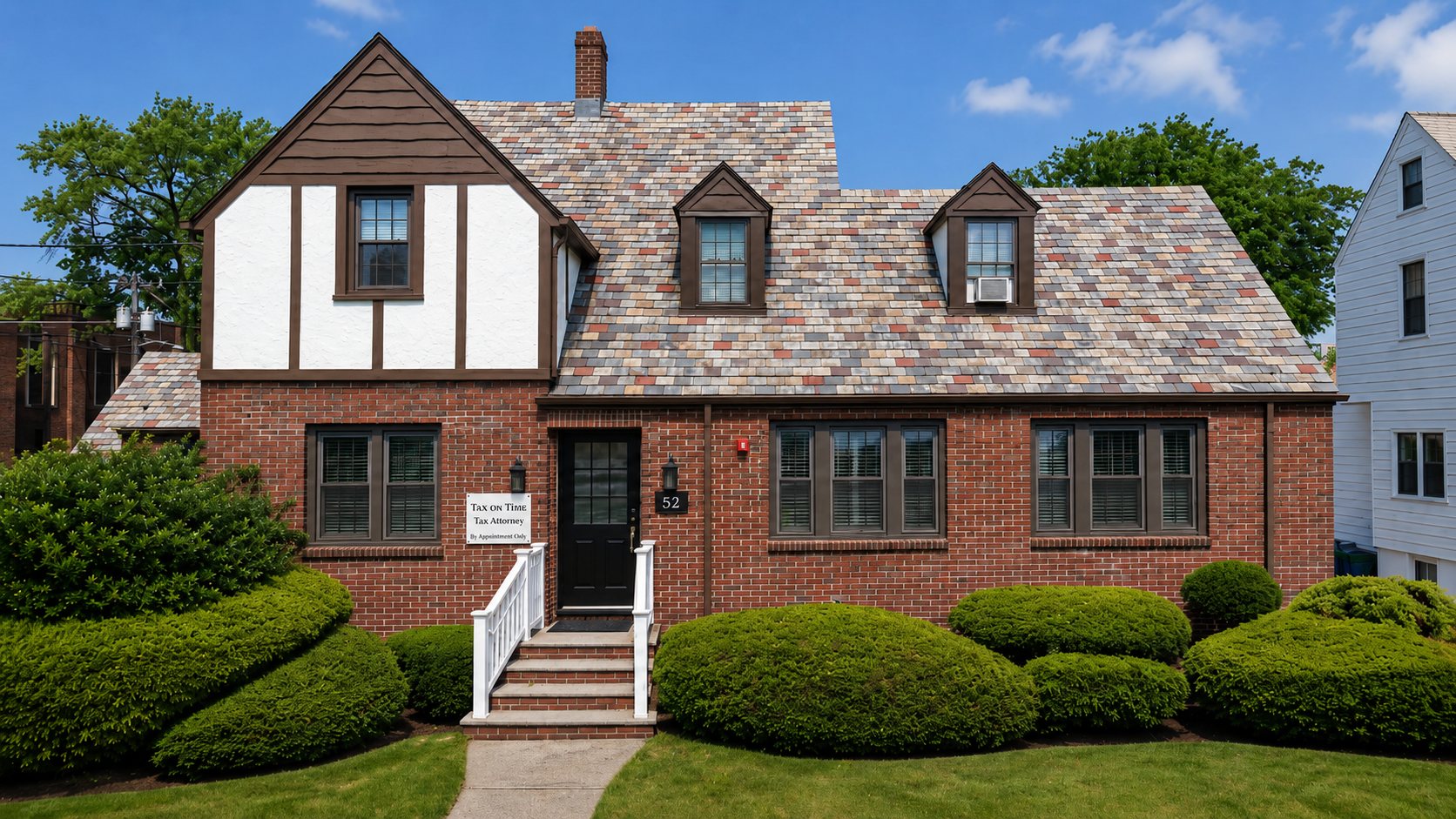 The Tax on Time office, a brick Tudor house at 52 Chestnut Street in Rutherford, New Jersey